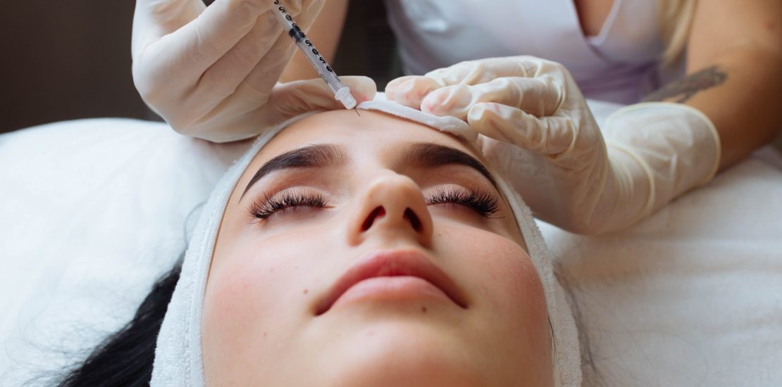 The doctor cosmetologist makes the Rejuvenating facial injections procedure for tightening and